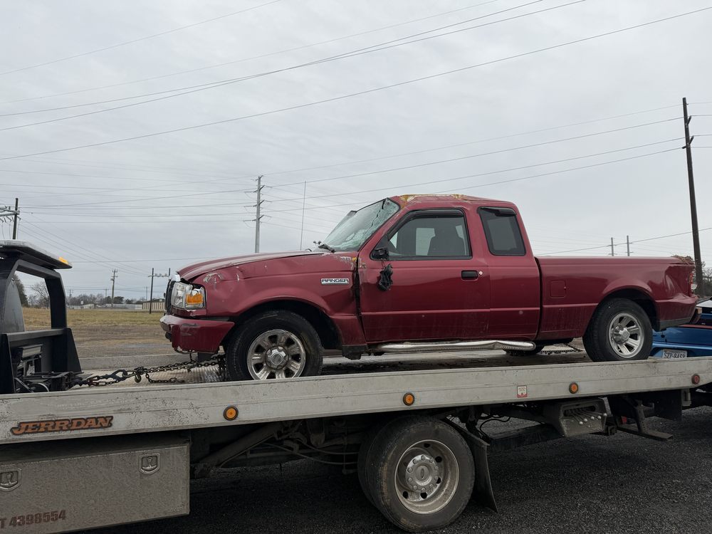 Red Ford Ranger secured on a D&K flatbed for transport
